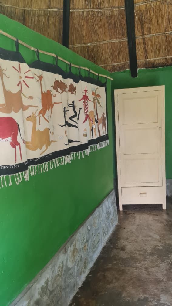 A chalet's painted walls, wall hanging and wardrobe