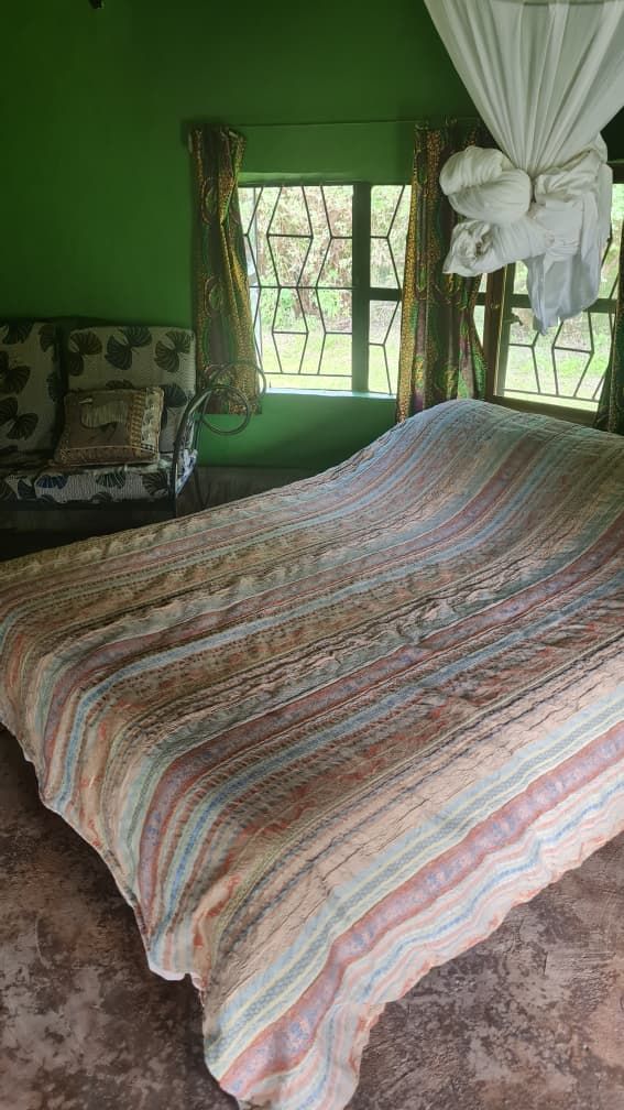 A double bed with mosquito net inside a chalet